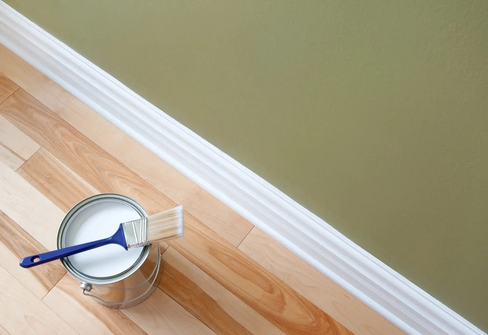 Paintbrush with fresh paint on wall Colorscape of Louisville Paint and Flooring